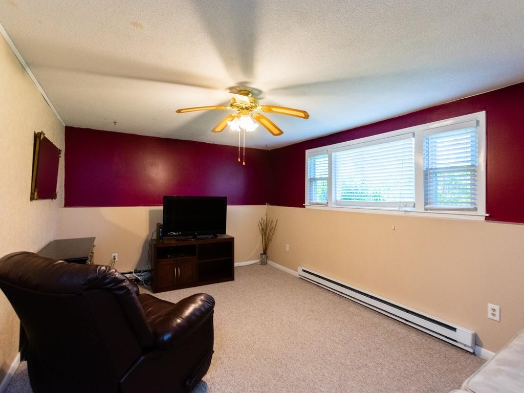 93 Graymore Road Waltham, MA 02451 - Photo 23 of 32 a living room with furniture and a flat screen tv