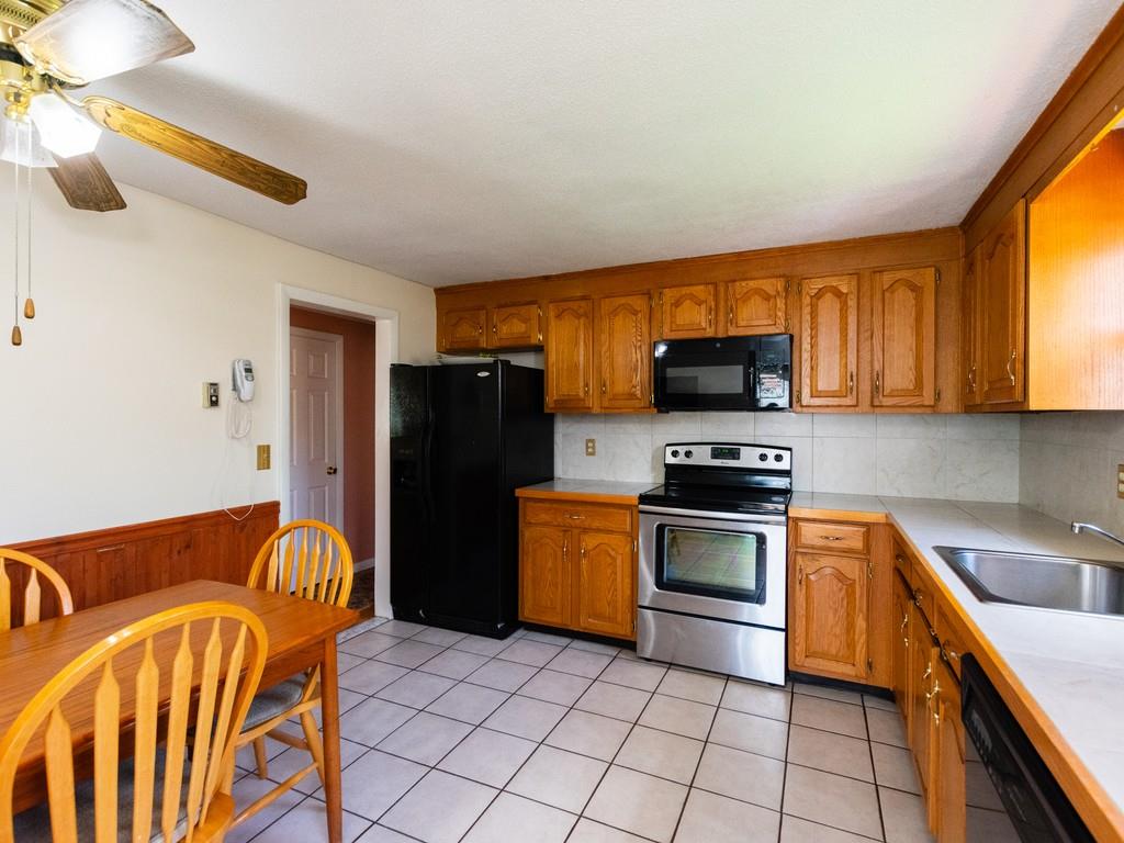 93 Graymore Road Waltham, MA 02451 - Photo 5 of 32 a kitchen with stainless steel appliances granite countertop a refrigerator and a stove top oven
