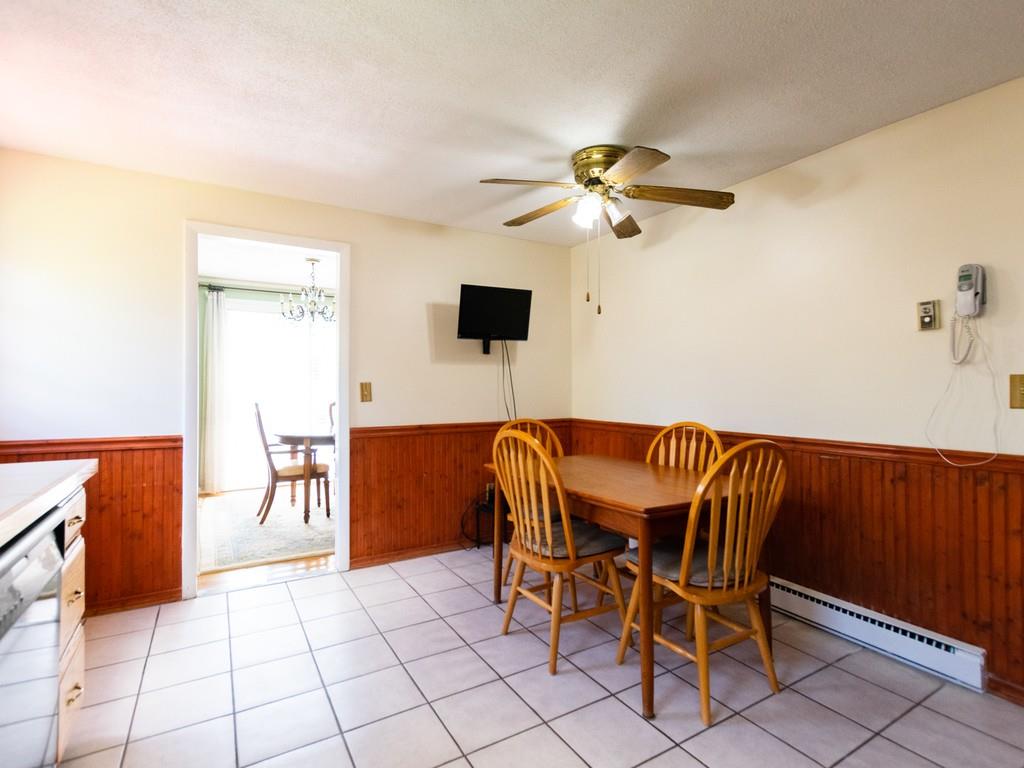 93 Graymore Road Waltham, MA 02451 - Photo 6 of 32 a view of a dining room with furniture and a chandelier fan