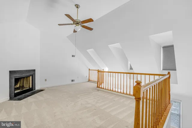 a view of a livingroom with a ceiling fan and window