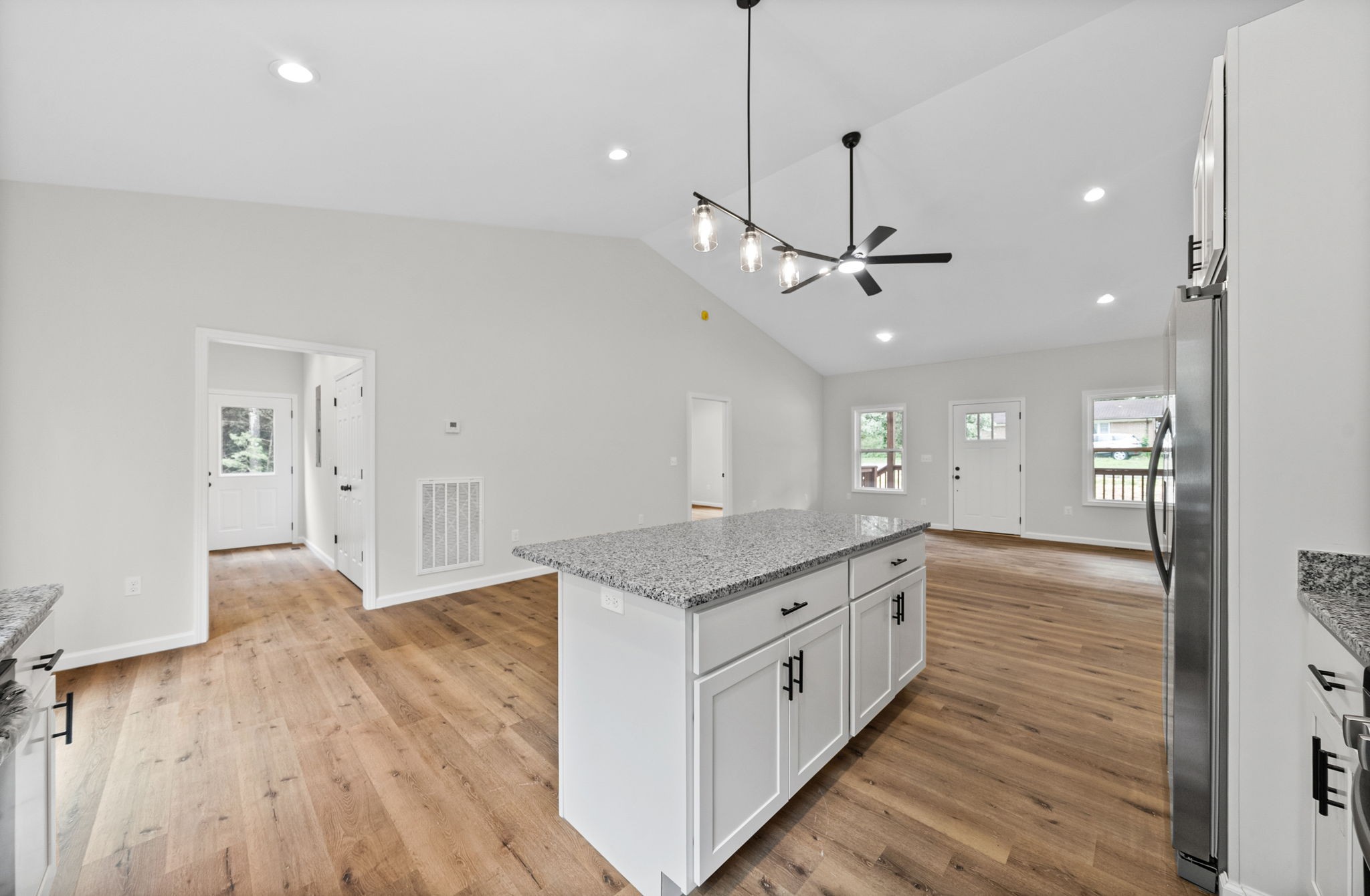 690 Brazzle Road Waverly, TN 37185 - Photo 15 of 35 a kitchen with stainless steel appliances granite countertop a hardwood floor sink stove and wooden floor