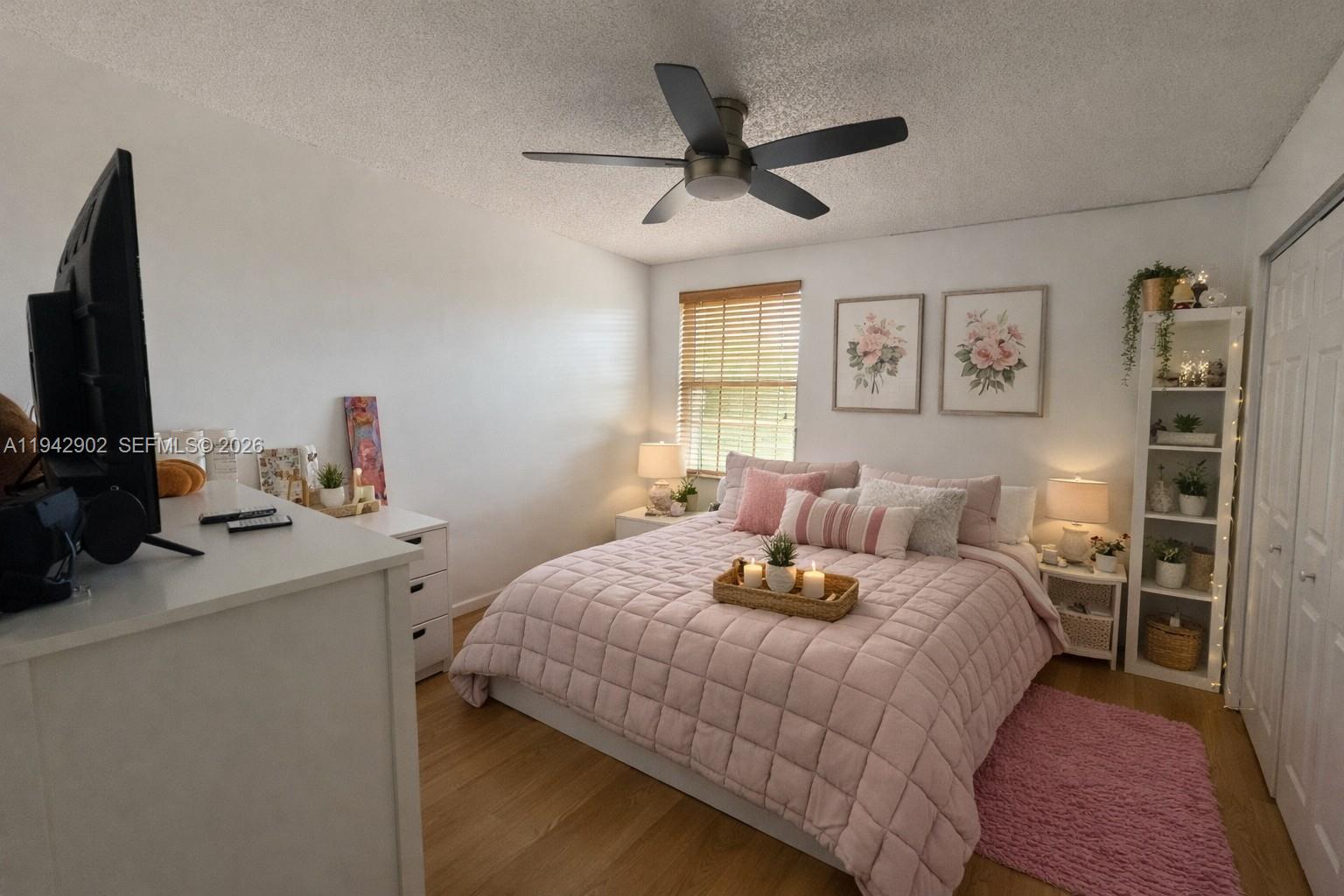 16276 Southwest 26th Street Miramar, FL 33027 - Photo 5 of 8 a bedroom with a bed and a flat screen tv