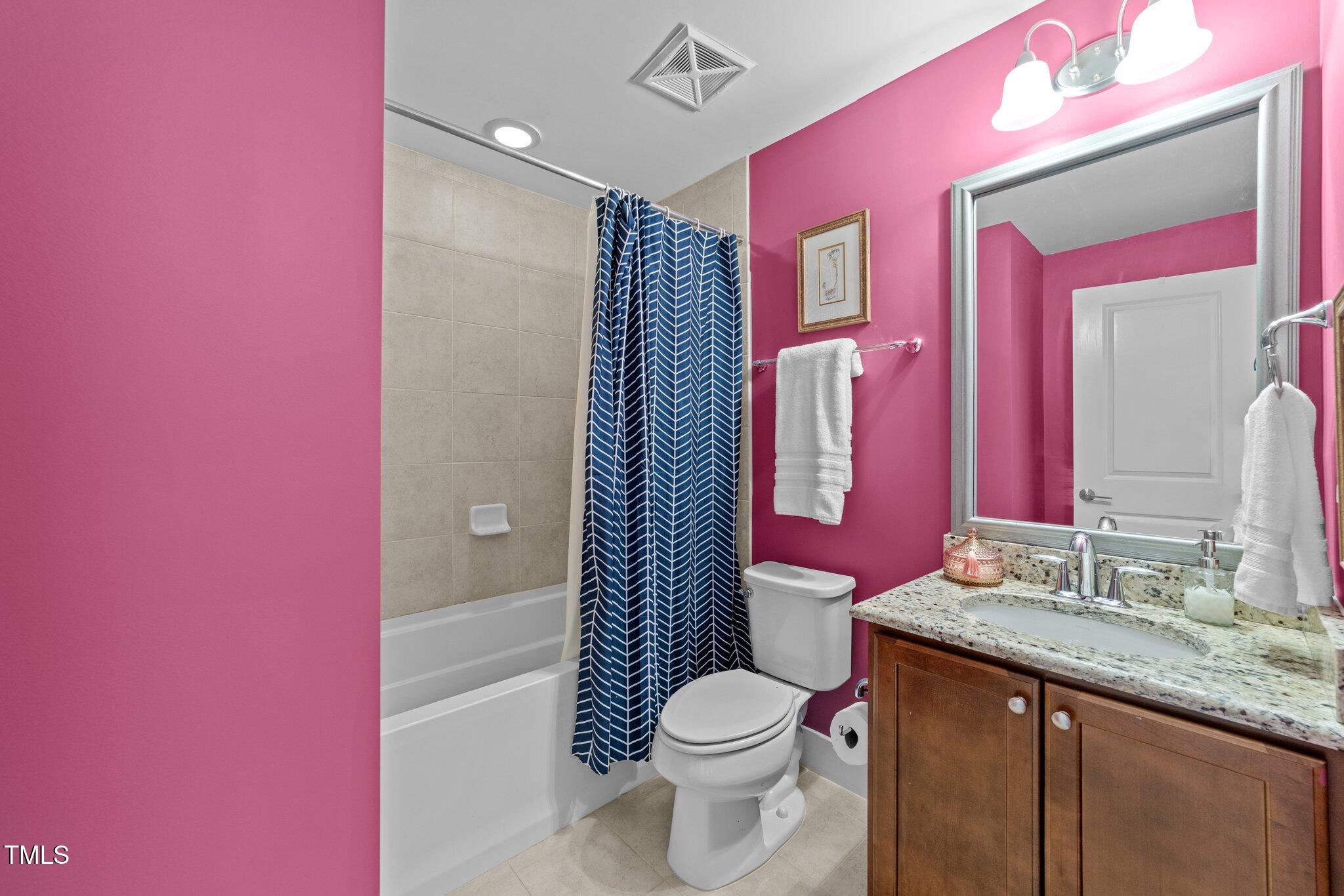 511 North Person Street, Unit 101 Raleigh, NC 27604 - Photo 11 of 35 a bathroom with a granite countertop toilet sink and mirror