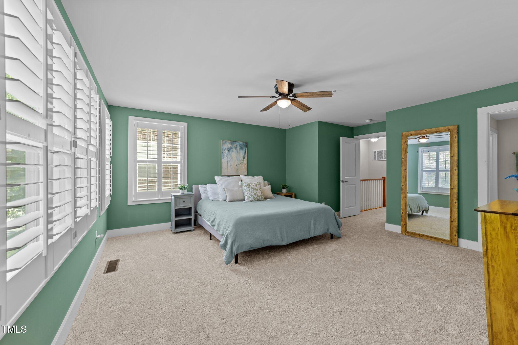 511 North Person Street, Unit 101 Raleigh, NC 27604 - Photo 20 of 35 a spacious bedroom with a large bed and a chandelier
