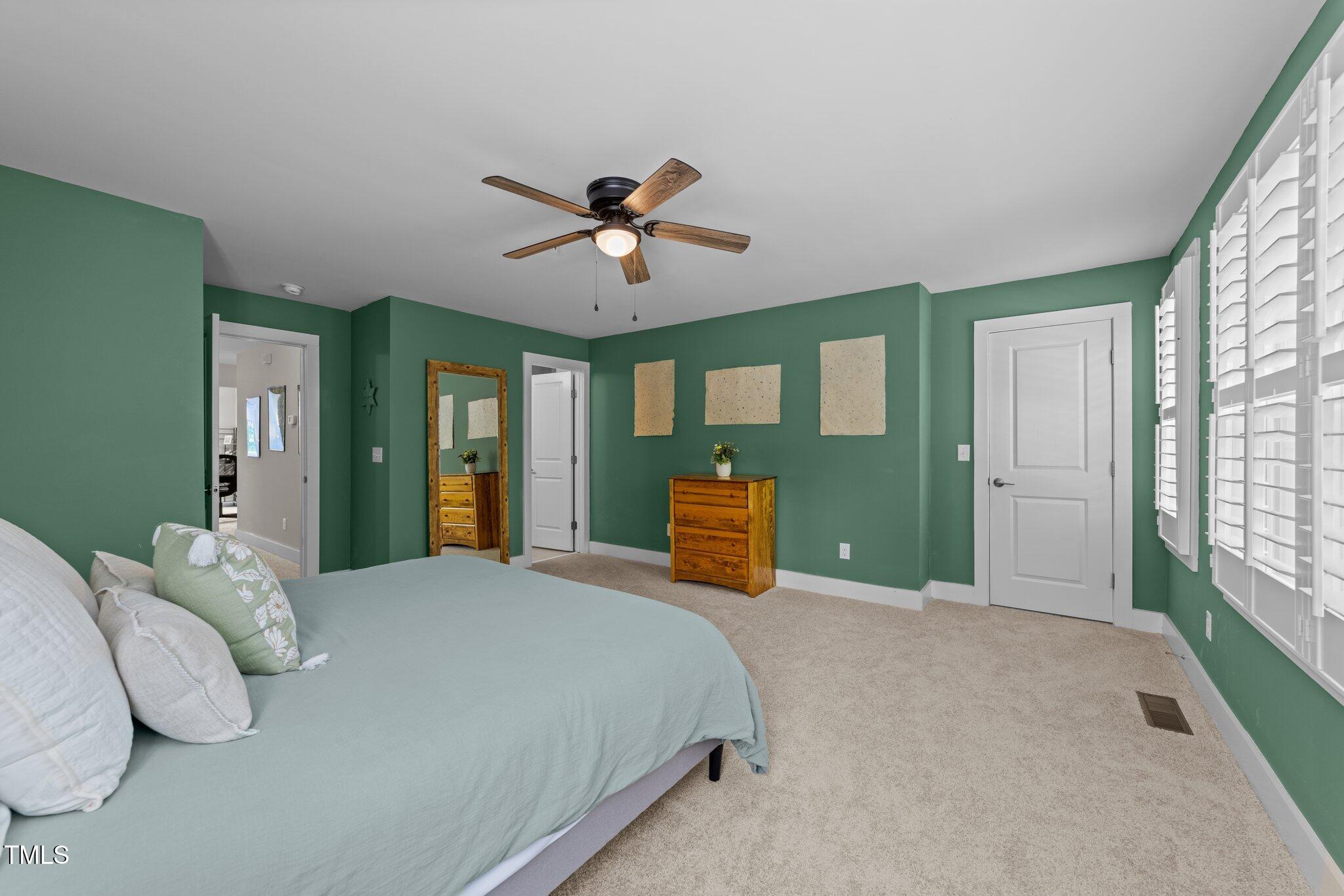 511 North Person Street, Unit 101 Raleigh, NC 27604 - Photo 21 of 35 a bedroom with a large bed and a chandelier