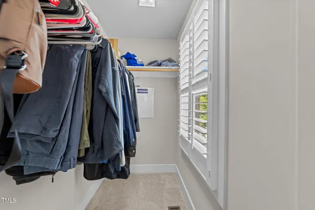 a view of walk in closet with clothes and shoes