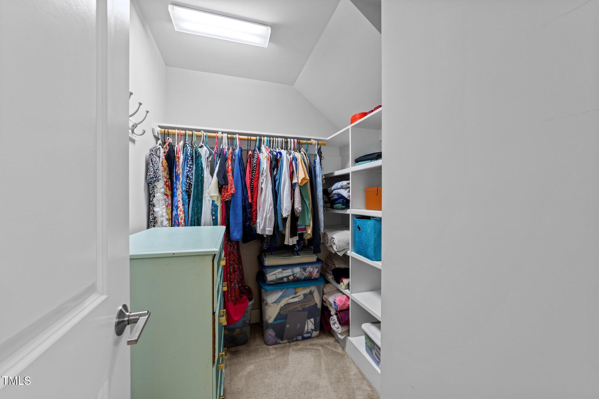 511 North Person Street, Unit 101 Raleigh, NC 27604 - Photo 25 of 35 a view of walk in closet with clothes and shoes