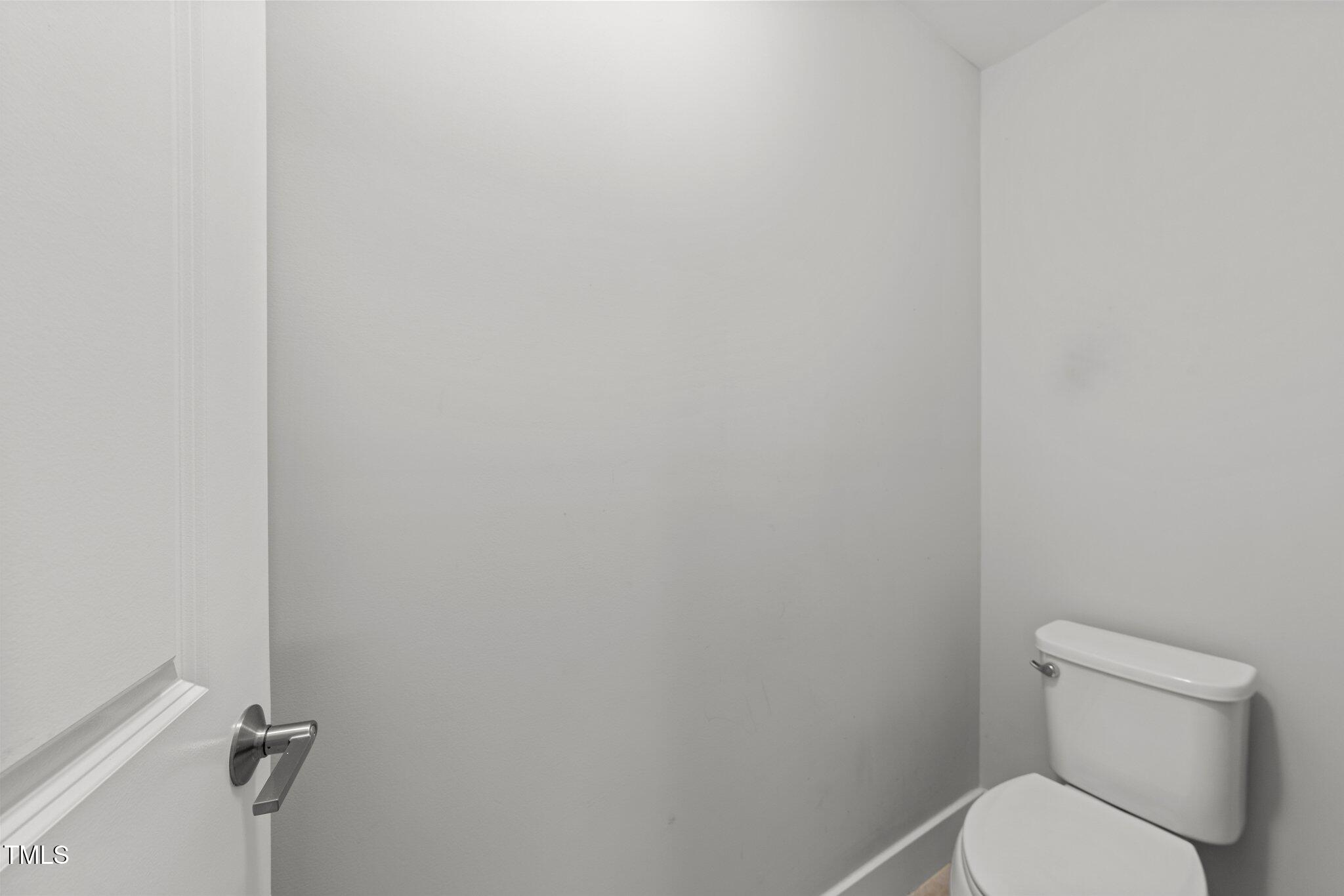 511 North Person Street, Unit 101 Raleigh, NC 27604 - Photo 26 of 35 a white toilet sitting next to a white wall