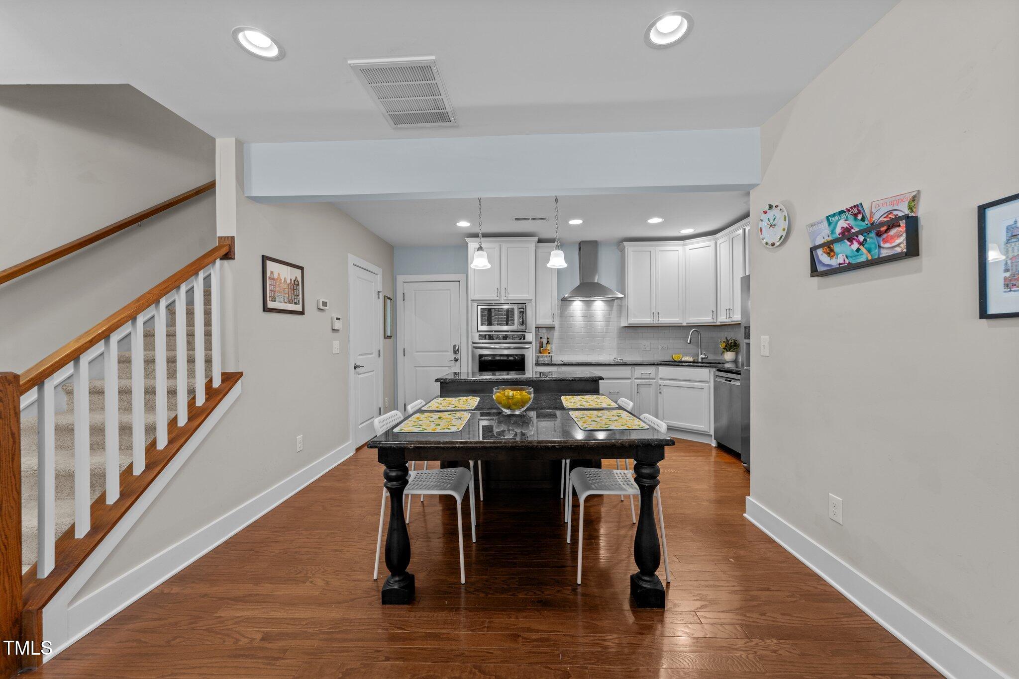 511 North Person Street, Unit 101 Raleigh, NC 27604 - Photo 6 of 35 a kitchen with a table and chairs in it