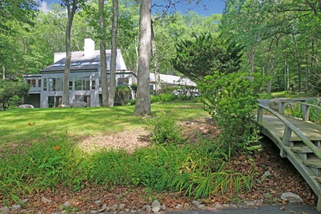 8 Rowledge Pond Road Newtown, CT 06482 - Photo 1 of 1 a view of a house with a big yard and large trees