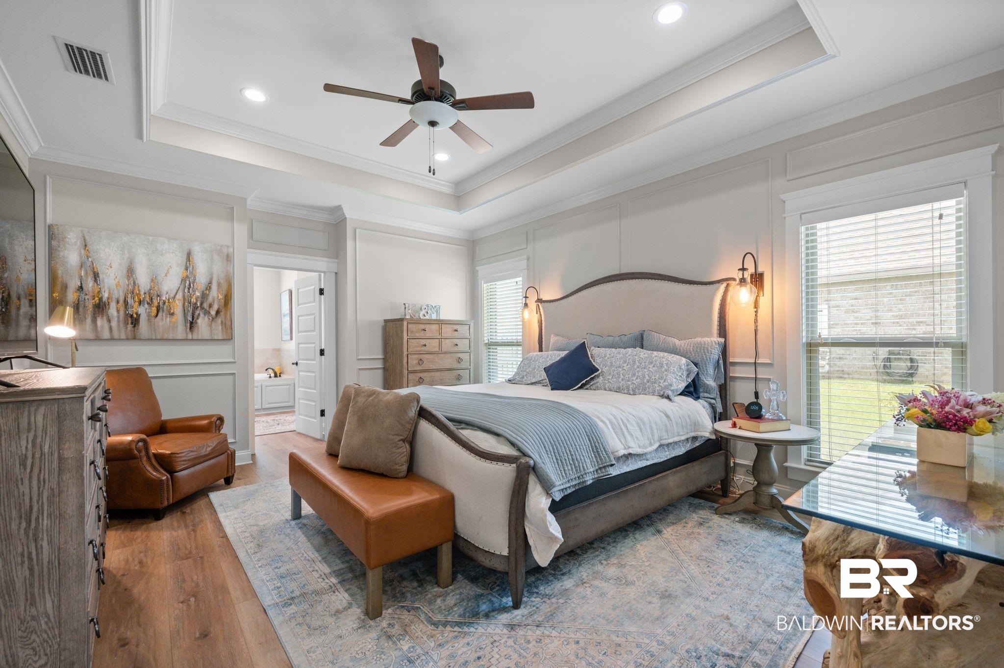 409 Fortune Drive Fairhope, AL 36532 - Photo 15 of 42 Spacious room featuring wood-finish flooring, a tray ceiling with recessed lighting and ceiling fan, two windows with blinds, and decorative wall paneling