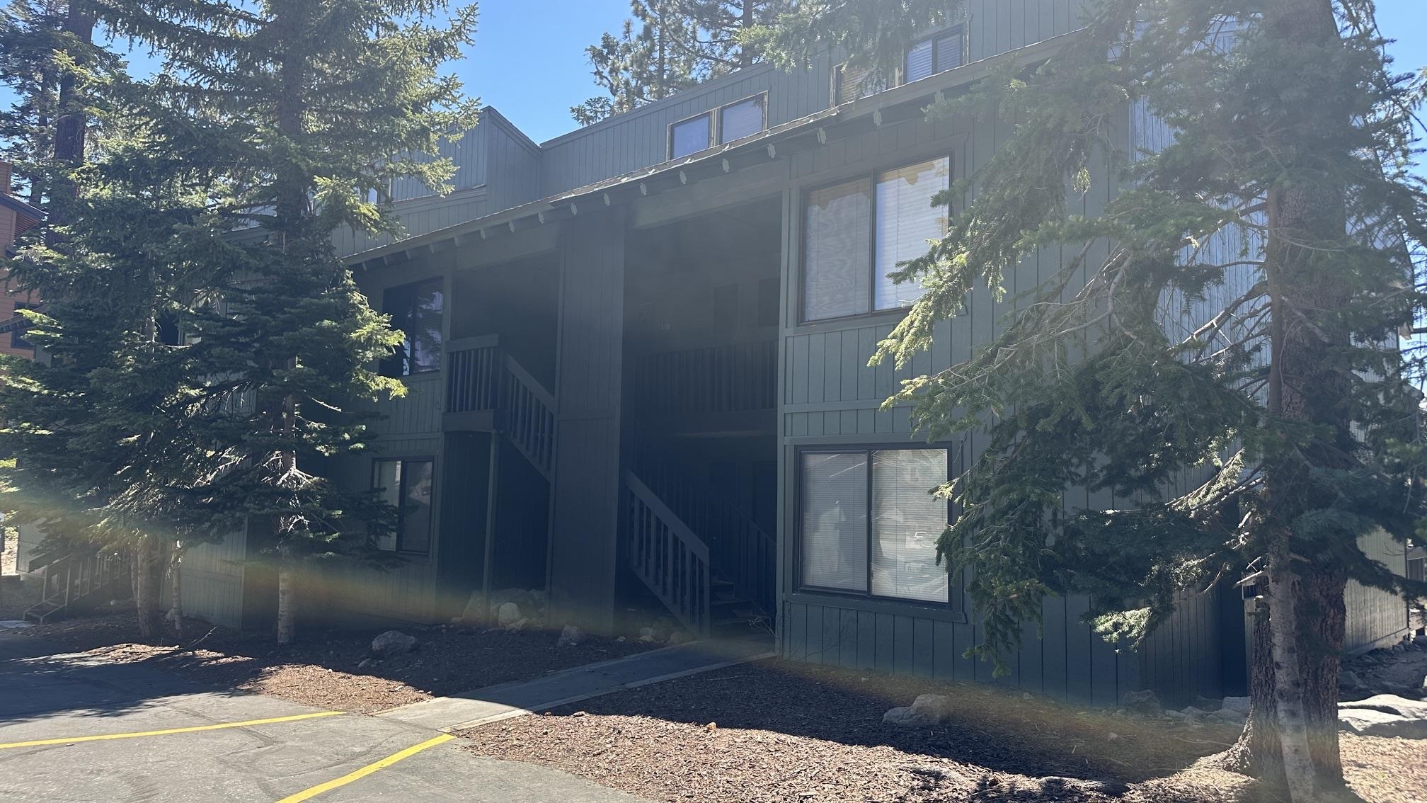 25 Lee Road, Unit 106 Mammoth Lakes, CA 93546 - Photo 16 of 16 Multi-story building featuring dark siding, visible windows, and exterior staircases