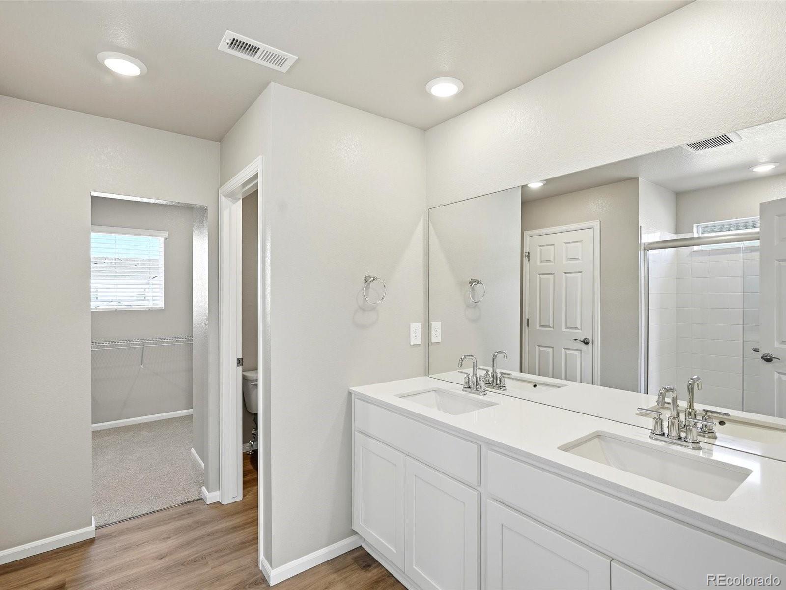 7317 West 27th St Road Greeley, CO 80634 - Photo 20 of 28 a bathroom with 2 sink shower and a mirror