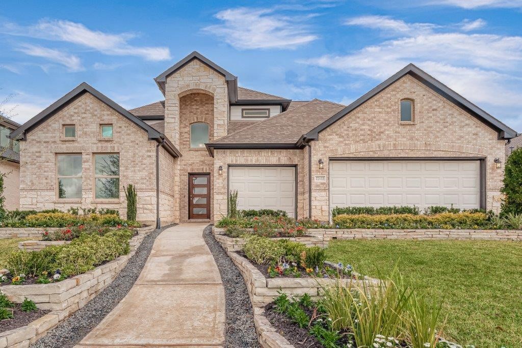 1061 Apple Ridge Road Magnolia, TX 77355 - Photo 1 of 49 a front view of a house with garden