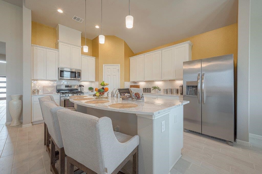 1061 Apple Ridge Road Magnolia, TX 77355 - Photo 12 of 49 a kitchen with kitchen island granite countertop a sink and refrigerator