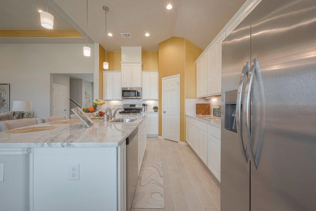 1061 Apple Ridge Road Magnolia, TX 77355 - Photo 13 of 49 a kitchen with stainless steel appliances granite countertop a sink a refrigerator and a stove