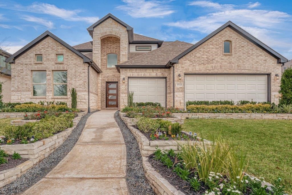 1061 Apple Ridge Road Magnolia, TX 77355 - Photo 2 of 49 a front view of a house with garden