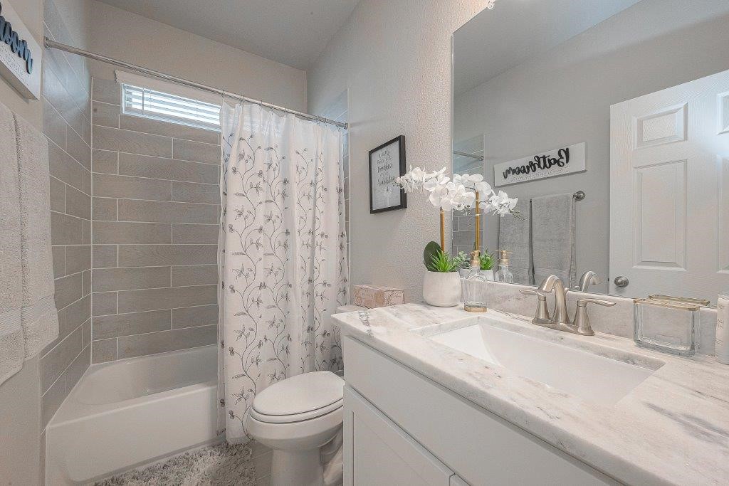 1061 Apple Ridge Road Magnolia, TX 77355 - Photo 24 of 49 a bathroom with a granite countertop sink a toilet and shower