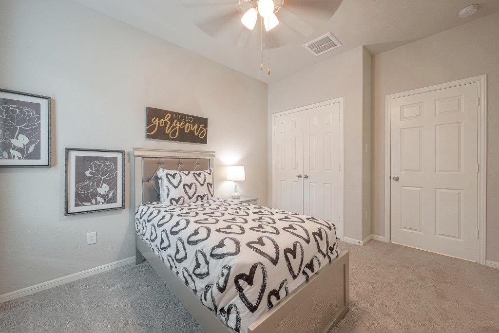 1061 Apple Ridge Road Magnolia, TX 77355 - Photo 29 of 49 a bedroom with a bed and a chandelier