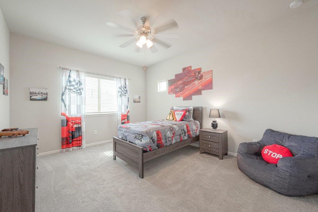 1061 Apple Ridge Road Magnolia, TX 77355 - Photo 31 of 49 a bedroom with a bed and a chandelier
