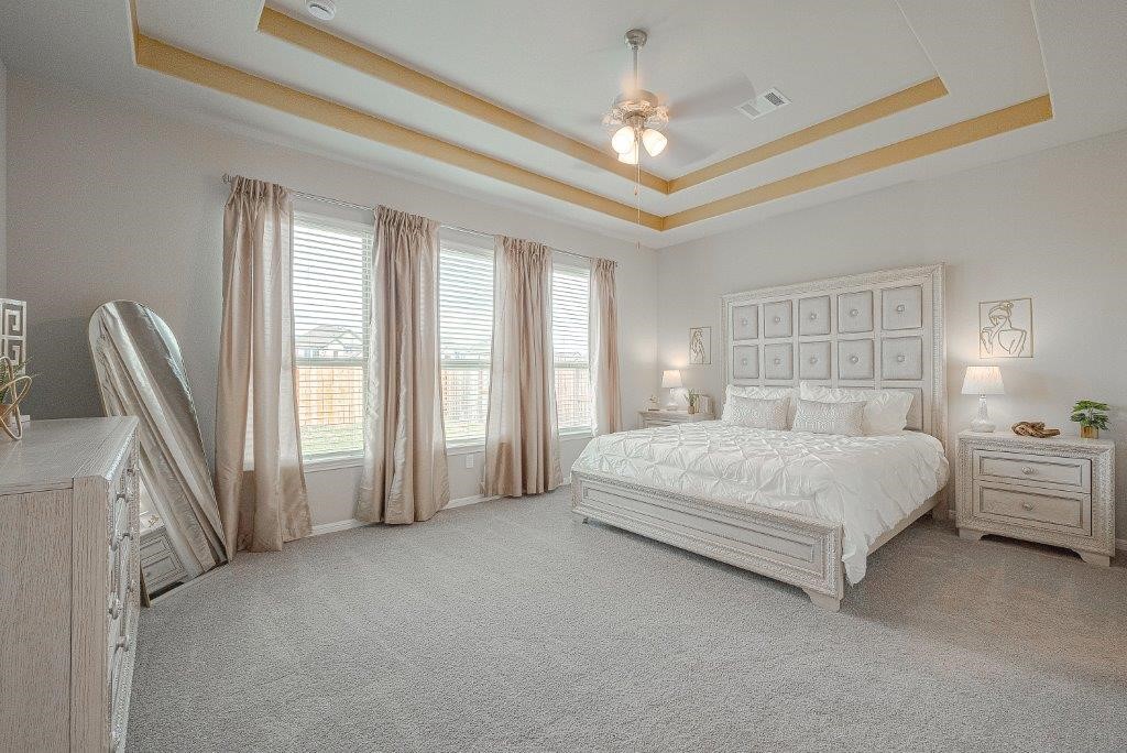 1061 Apple Ridge Road Magnolia, TX 77355 - Photo 35 of 49 a spacious bedroom with a large bed and a chandelier