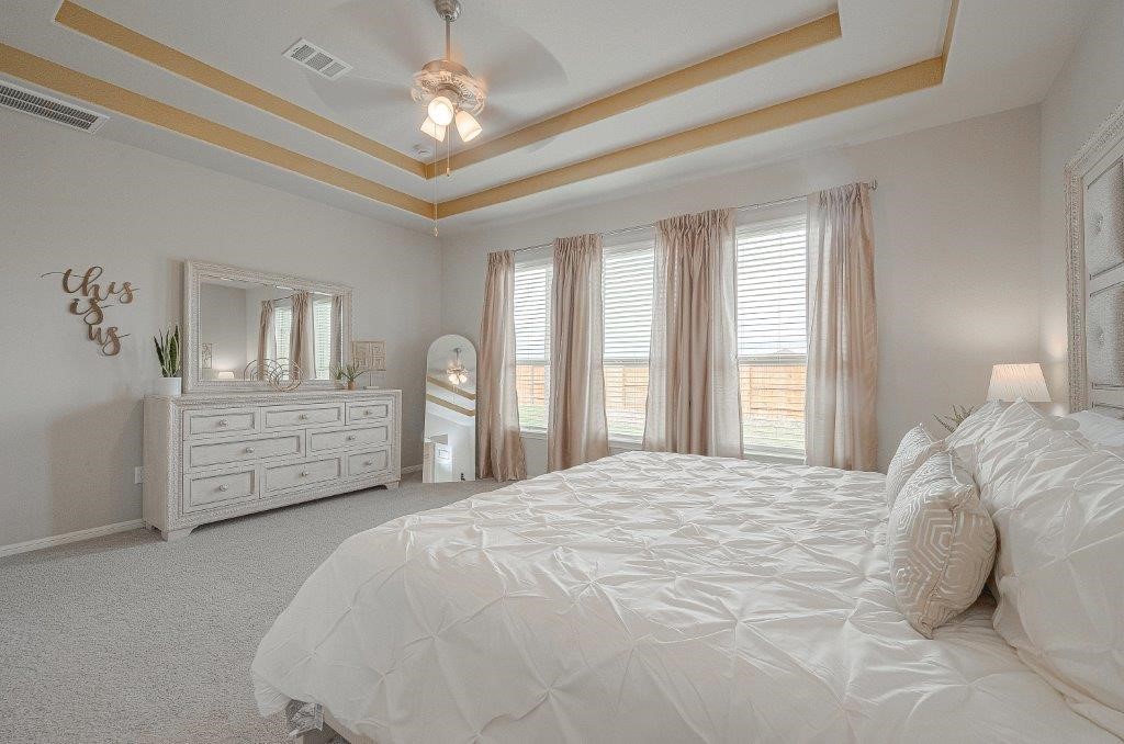 1061 Apple Ridge Road Magnolia, TX 77355 - Photo 38 of 49 a spacious bedroom with a bed a dresser and a chandelier