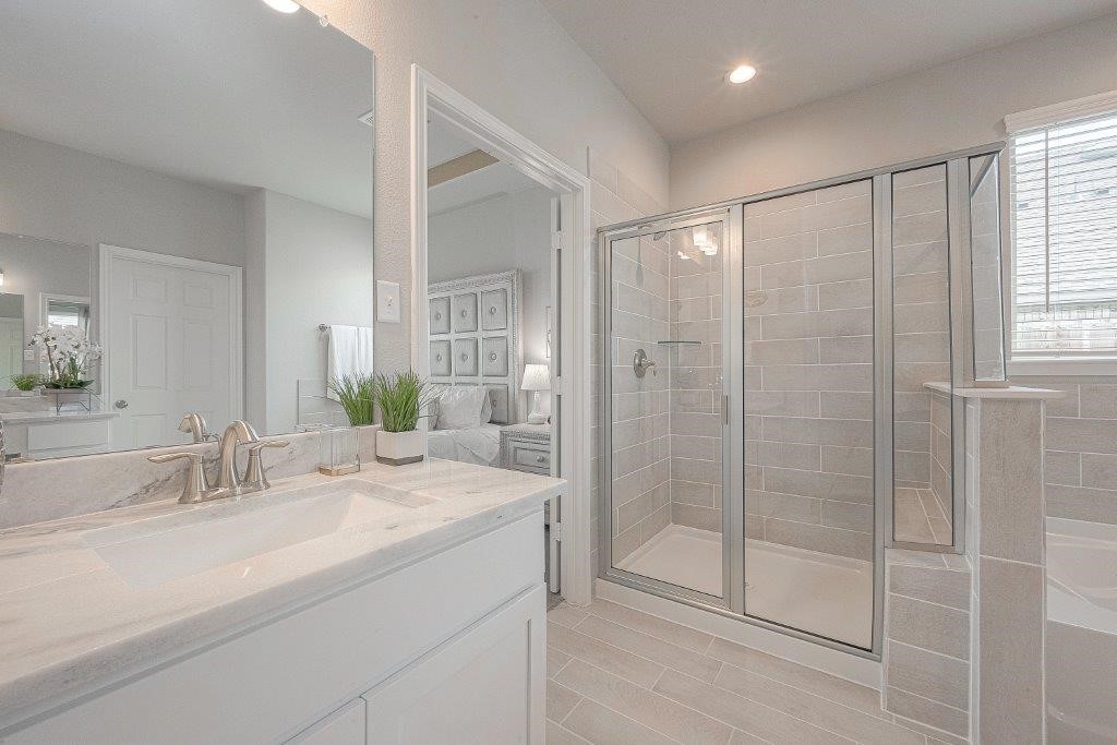1061 Apple Ridge Road Magnolia, TX 77355 - Photo 42 of 49 a bathroom with a shower sink and mirror