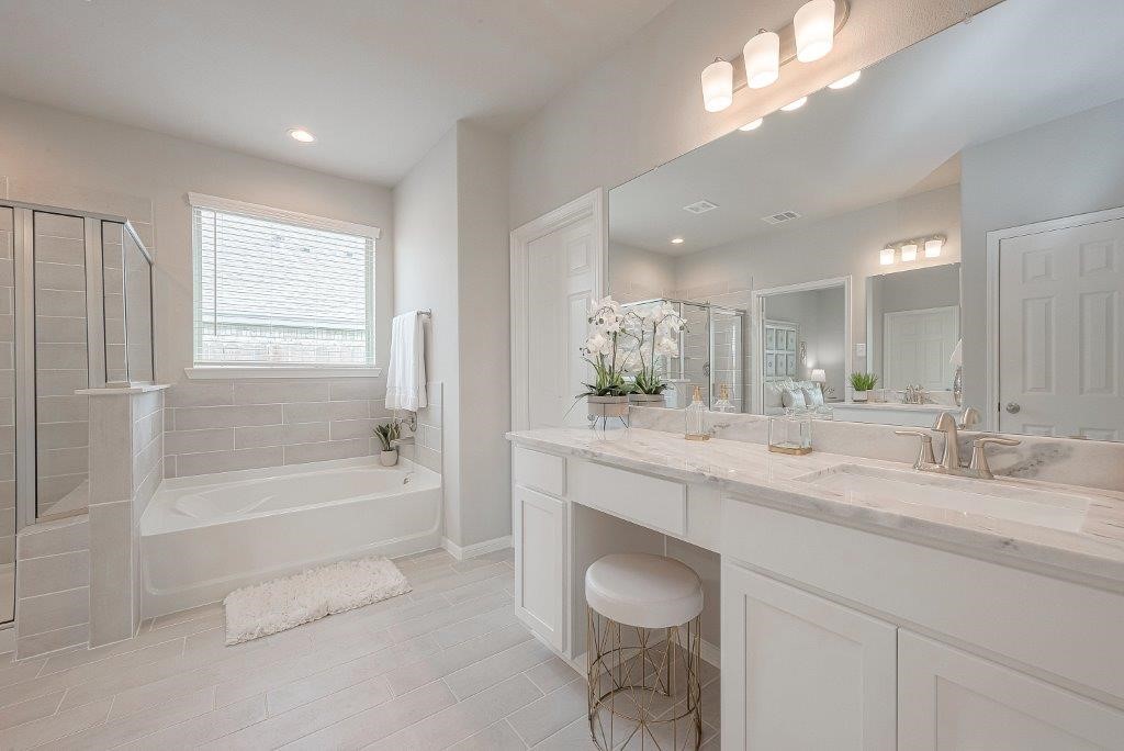 1061 Apple Ridge Road Magnolia, TX 77355 - Photo 43 of 49 a bathroom with a granite countertop sink a toilet a mirror and bathtub
