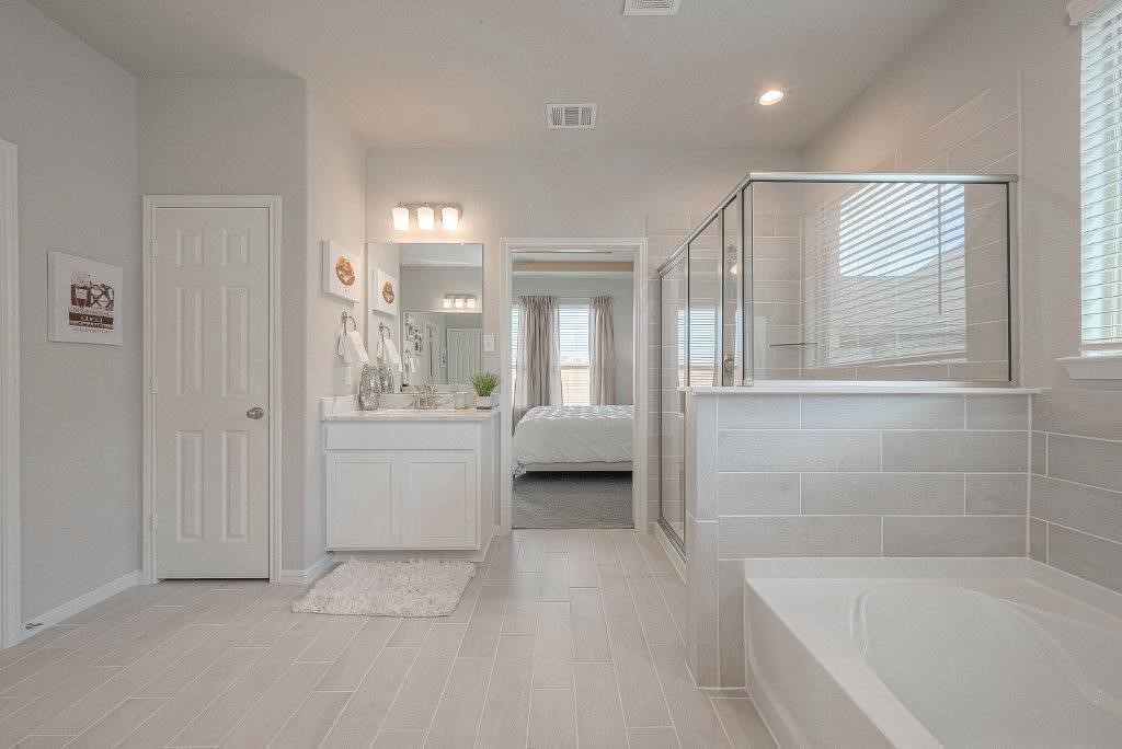 1061 Apple Ridge Road Magnolia, TX 77355 - Photo 45 of 49 a bathroom with a tub shower and sink