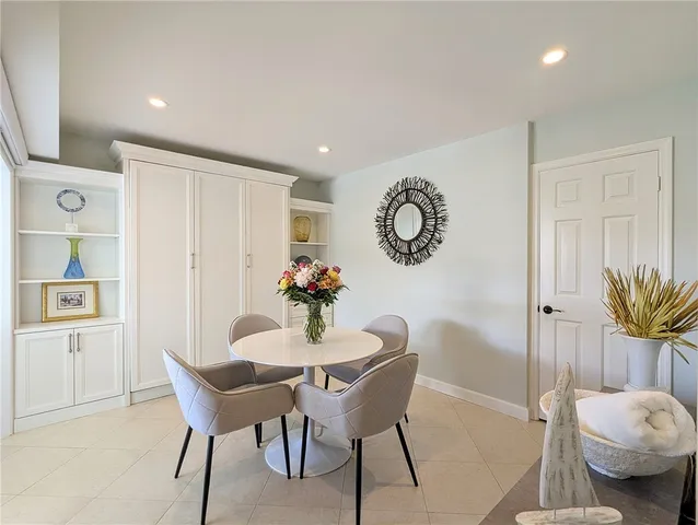 a view of a dining room with furniture and a large window