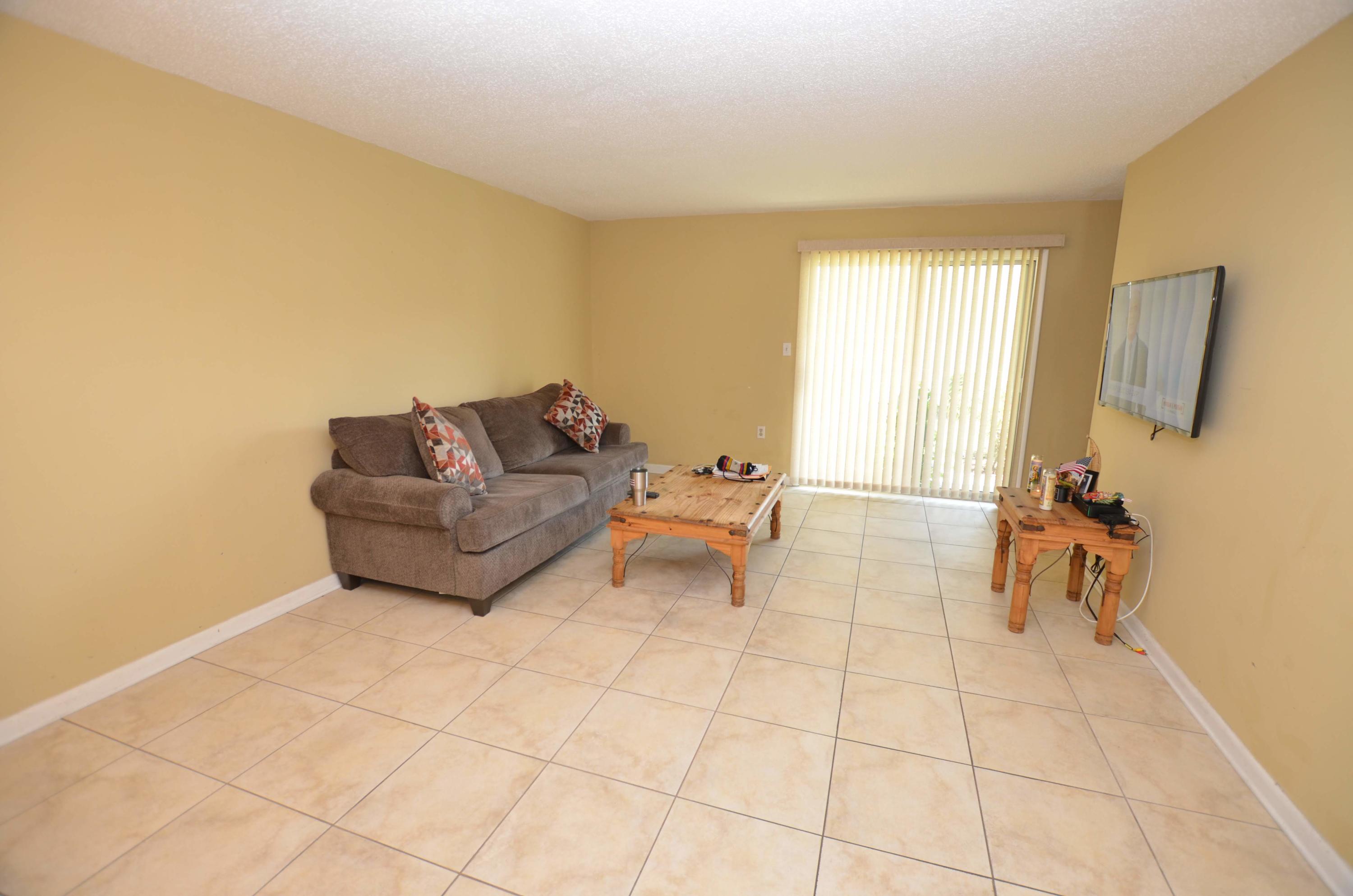 81 Cross Creek Road, Unit 22 Miramar Beach, FL 32550 - Photo 2 of 13 a living room with furniture and a flat screen tv