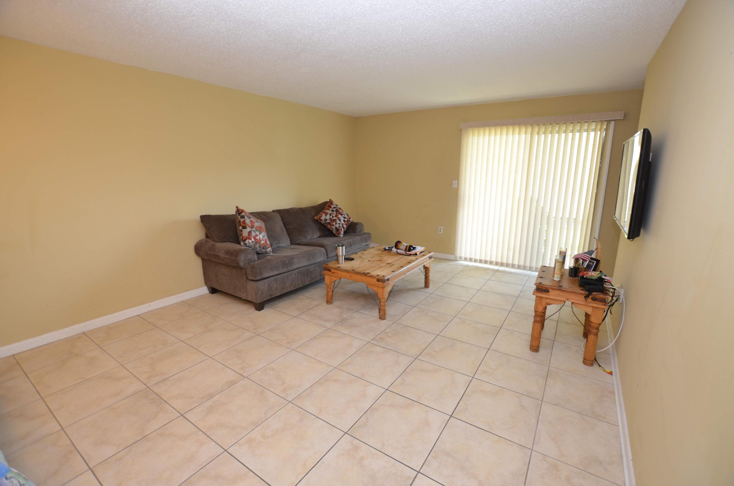 81 Cross Creek Road, Unit 22 Miramar Beach, FL 32550 - Photo 3 of 13 a living room with furniture and a flat screen tv