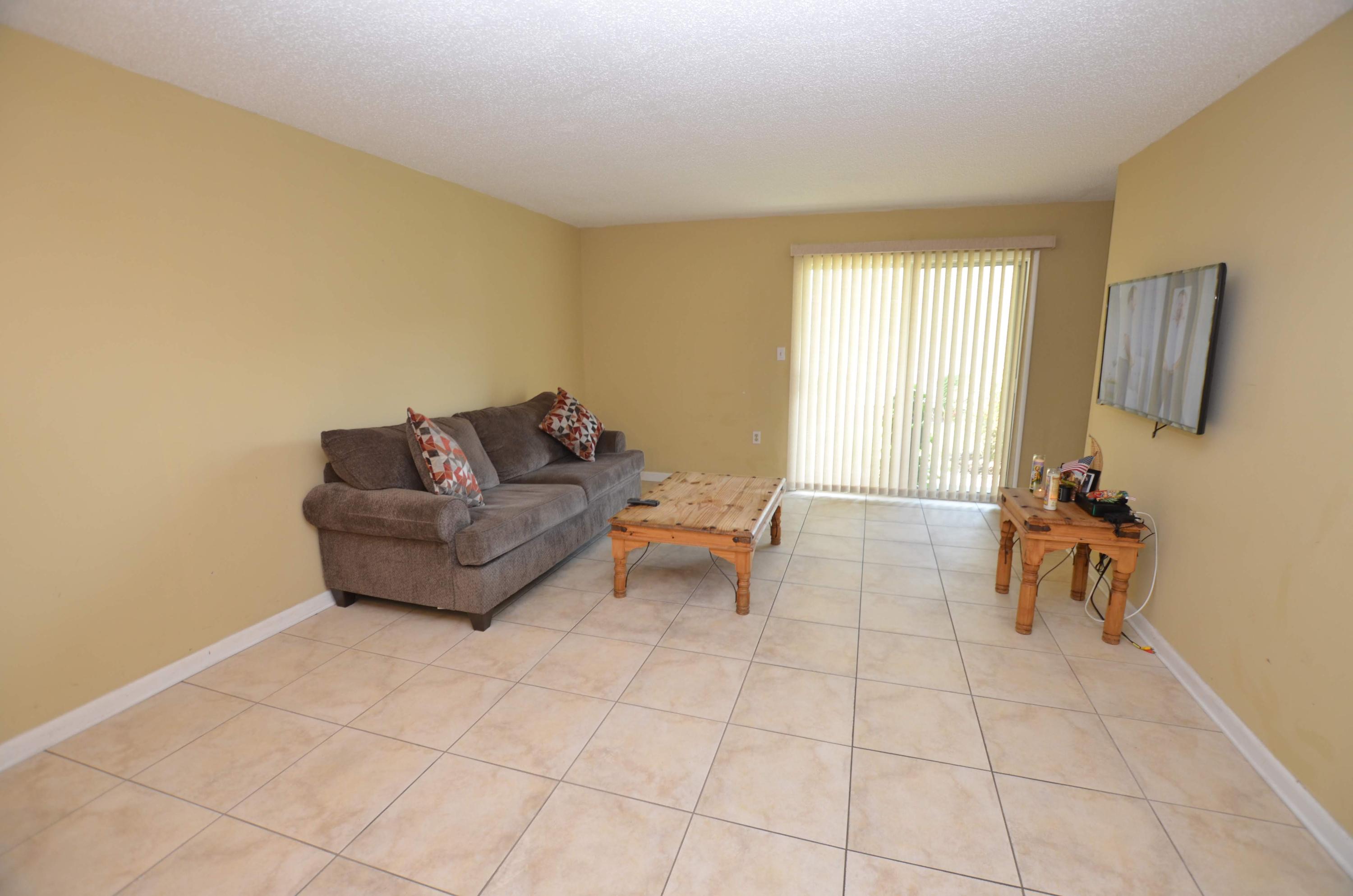 81 Cross Creek Road, Unit 22 Miramar Beach, FL 32550 - Photo 7 of 13 a living room with furniture and a window