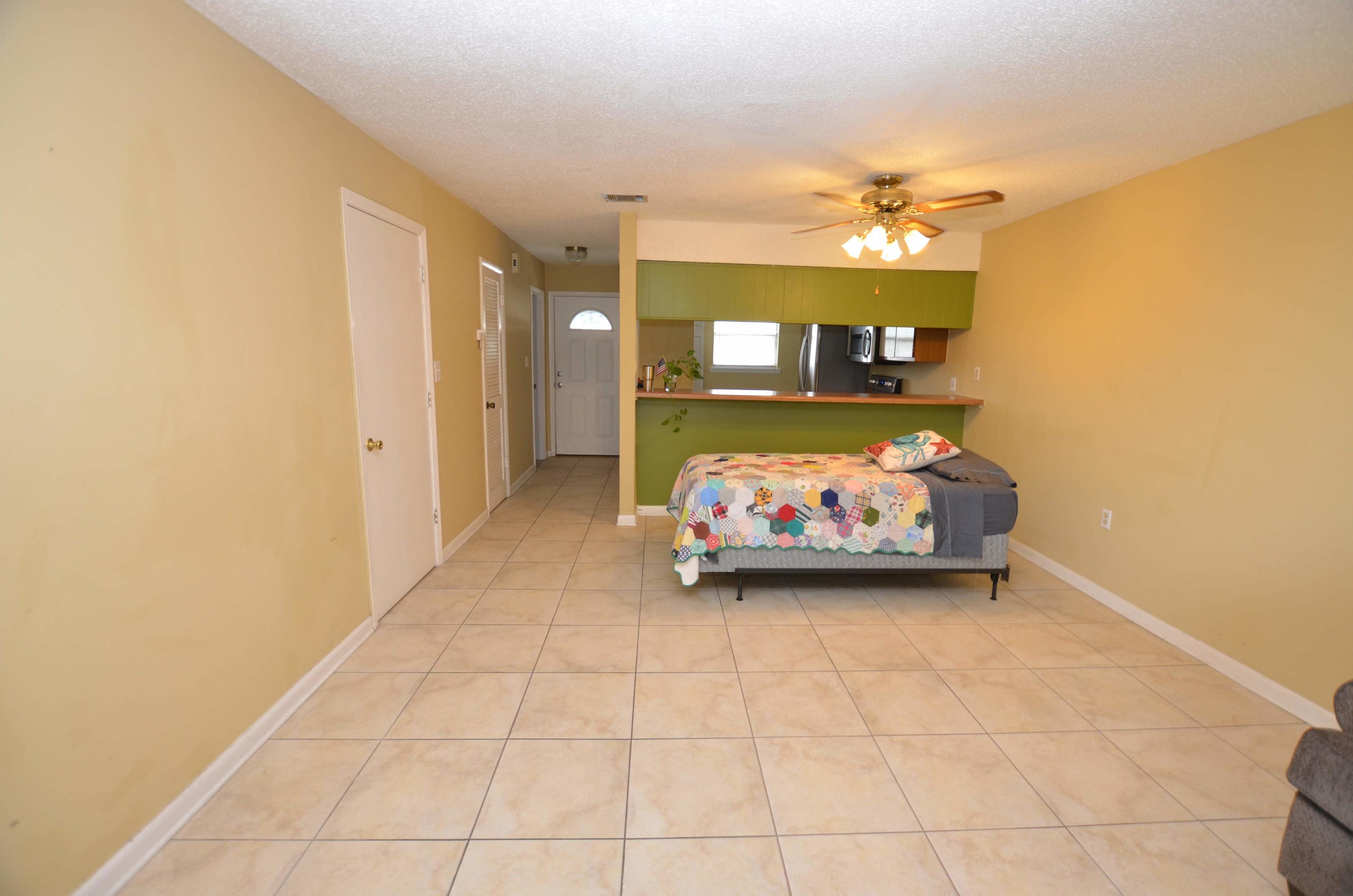 81 Cross Creek Road, Unit 22 Miramar Beach, FL 32550 - Photo 9 of 13 a view of a livingroom with furniture and a ceiling fan
