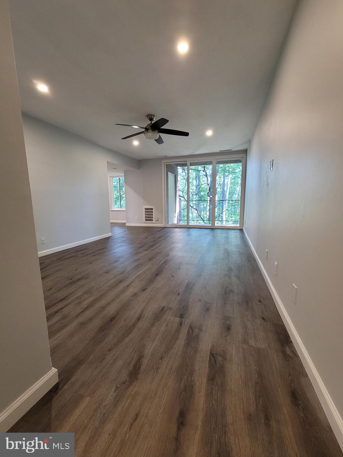 5049 7th Road South, Unit 201 Arlington, VA 22204 - Photo 2 of 45 an empty room with wooden floor and windows