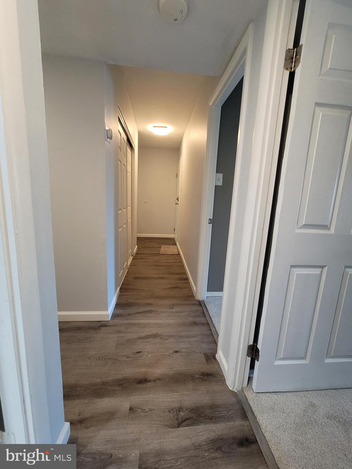 5049 7th Road South, Unit 201 Arlington, VA 22204 - Photo 21 of 45 a view of a hallway with wooden floor and staircase