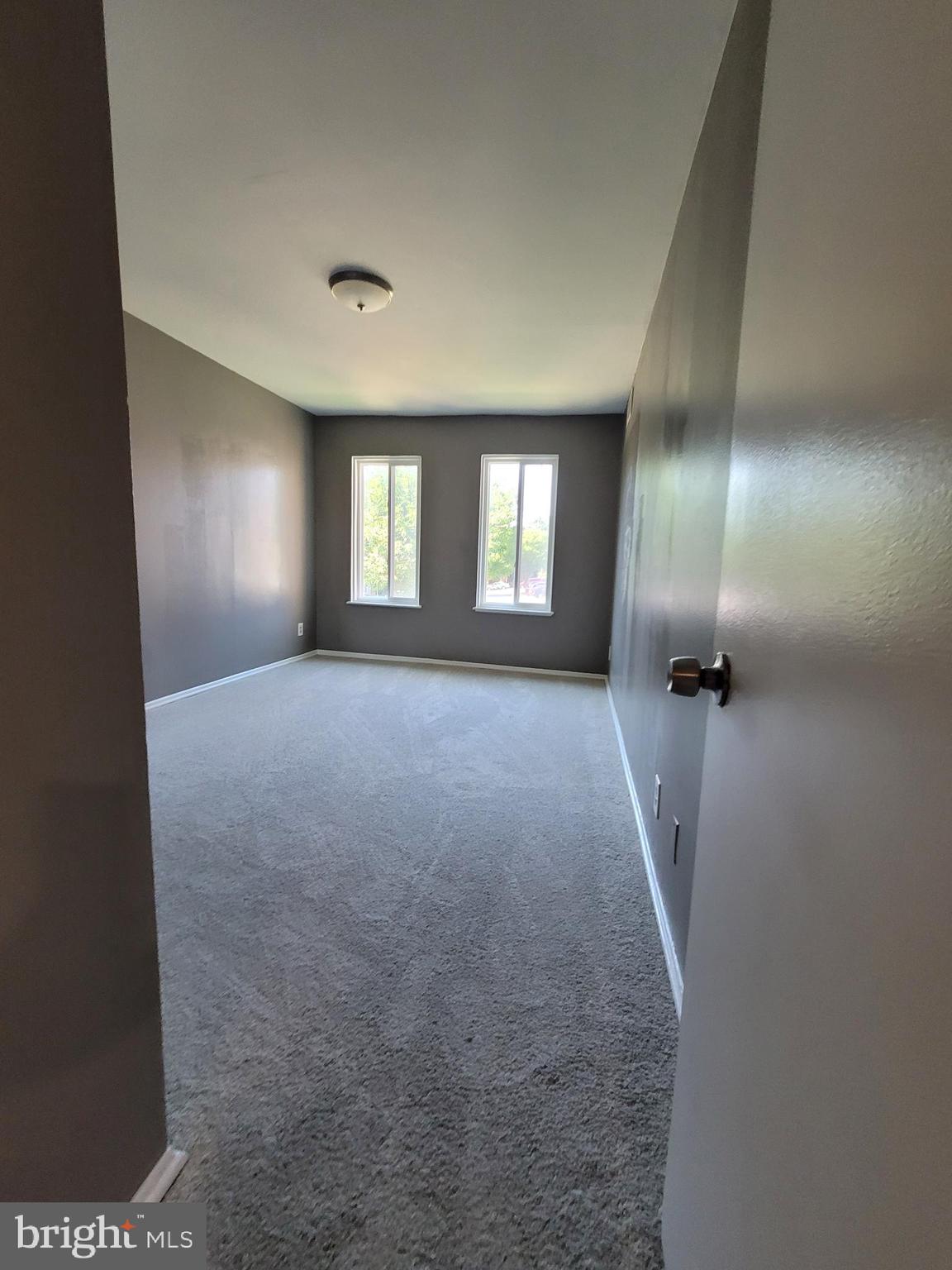 5049 7th Road South, Unit 201 Arlington, VA 22204 - Photo 32 of 45 en empty room with windows and brick walls