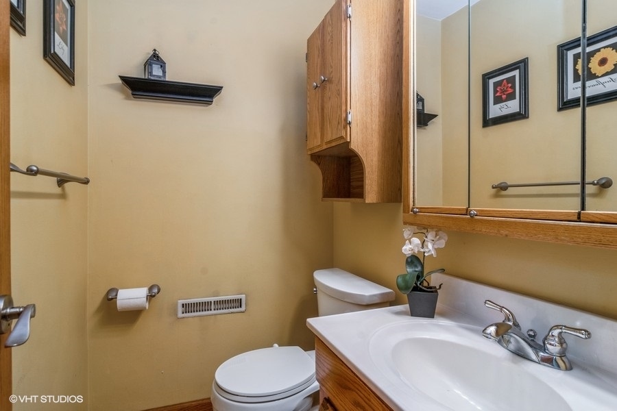 28 Jack Street Plano, IL 60545 - Photo 12 of 21 a bathroom with a toilet sink and mirror