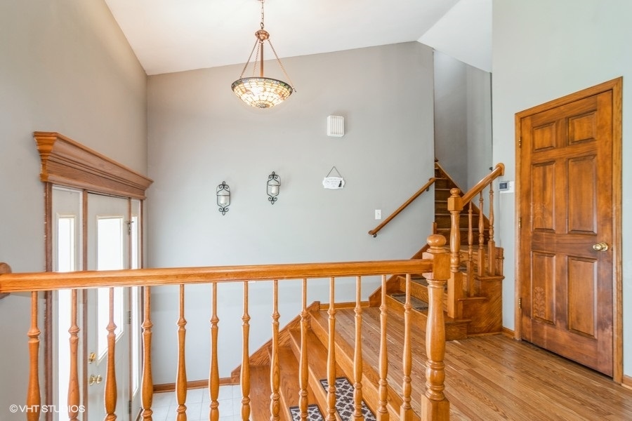 28 Jack Street Plano, IL 60545 - Photo 13 of 21 a view of a hallway with wooden floor and staircase