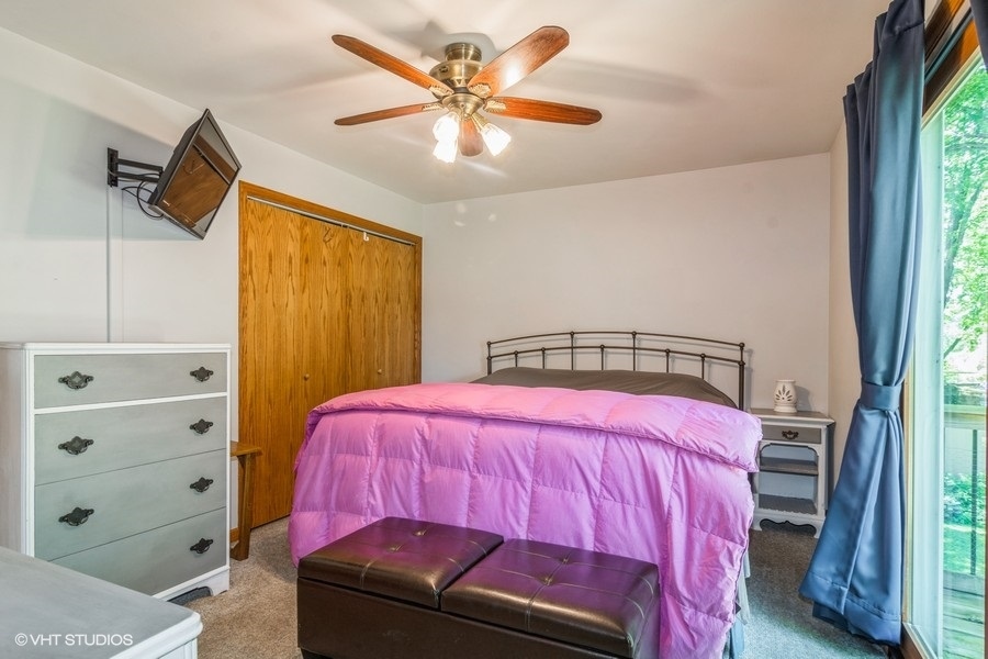 28 Jack Street Plano, IL 60545 - Photo 14 of 21 a bedroom with a bed and a window