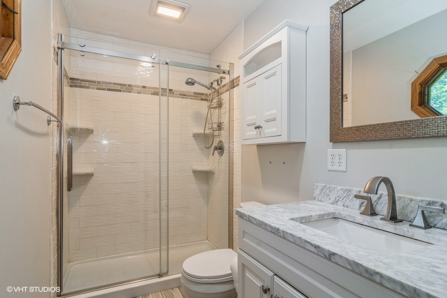 28 Jack Street Plano, IL 60545 - Photo 15 of 21 a bathroom with a granite countertop shower sink vanity mirror and toilet