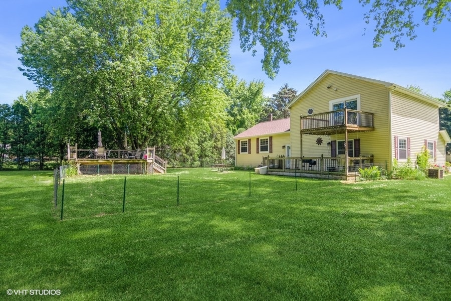 28 Jack Street Plano, IL 60545 - Photo 19 of 21 a view of house with a big yard and large trees