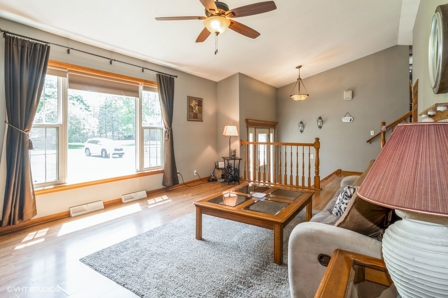 28 Jack Street Plano, IL 60545 - Photo 7 of 21 a living room with furniture and a large window