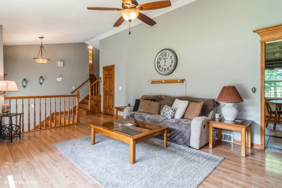 28 Jack Street Plano, IL 60545 - Photo 8 of 21 a living room with furniture and a wooden floor