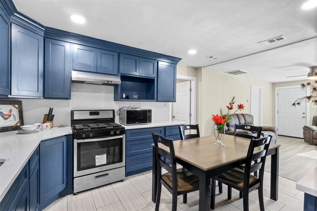 10319 Old Seagoville Road Dallas, TX 75217 - Photo 13 of 14 a kitchen with a stove a sink and a refrigerator