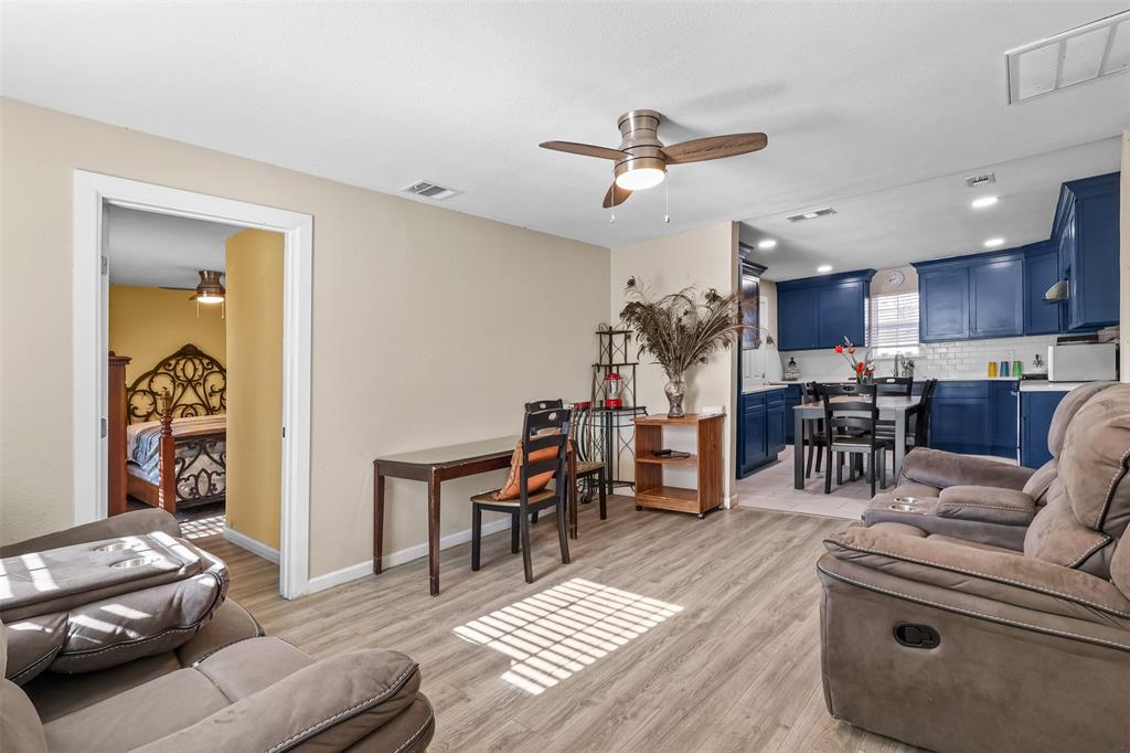 10319 Old Seagoville Road Dallas, TX 75217 - Photo 2 of 14 a living room with furniture and a dining table with kitchen view