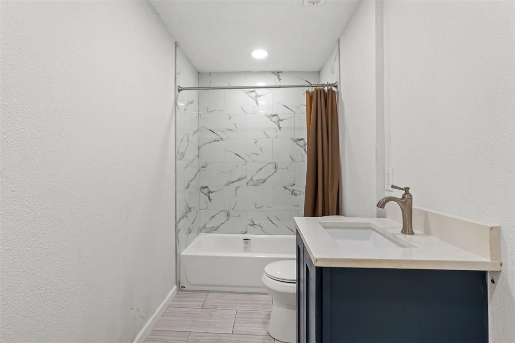 10319 Old Seagoville Road Dallas, TX 75217 - Photo 6 of 14 a bathroom with a bathtub and a sink