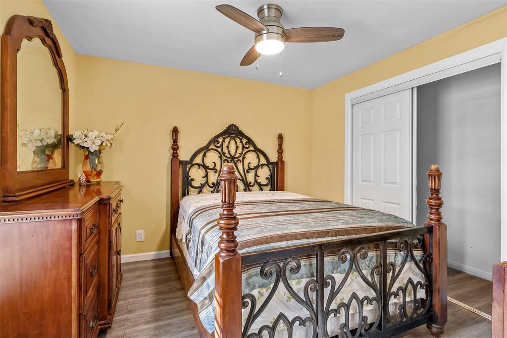 10319 Old Seagoville Road Dallas, TX 75217 - Photo 7 of 14 a bedroom with a bed and a chandelier