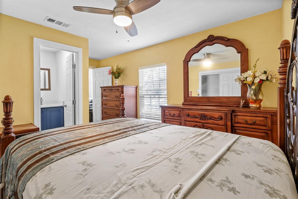 10319 Old Seagoville Road Dallas, TX 75217 - Photo 8 of 14 a bedroom with a bed and a dresser