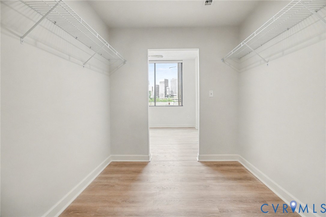 1101 Haxall Point, Unit U711 Richmond, VA 23219 - Photo 13 of 47 a view of an empty room with wooden floor and a window
